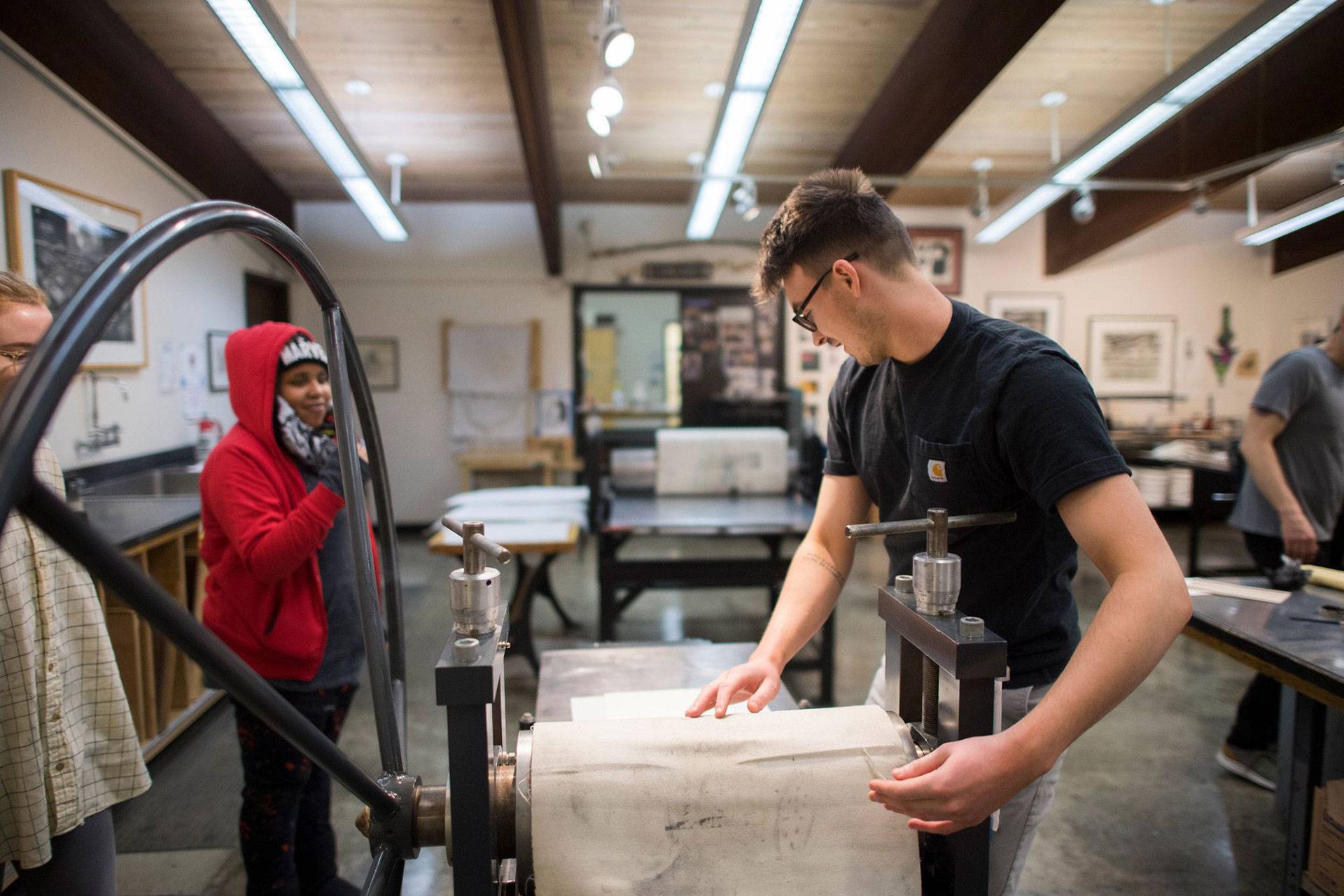 Studio Art Student wearing a black shirt in the Printmaking Studio